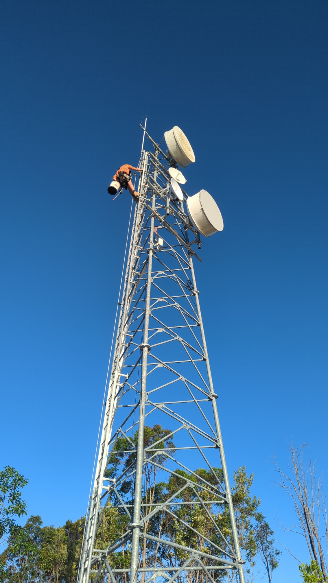Technician working on the communications tower for the Tangalooma project